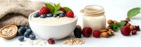 Healthy breakfast bowl with fresh berries, yogurt, oats and nuts on rustic wooden background. Nutritious morning meal concept for wellness lifestyle.