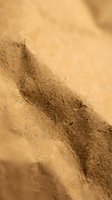 Close-up of golden sand dunes with natural wind patterns and textures creating abstract desert landscape background for travel and nature designs.