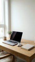 Modern minimalist home office workspace with laptop computer on wooden desk near window with natural light for remote work and productivity.