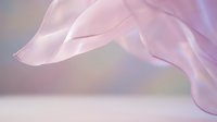 Soft pink translucent fabric flowing gracefully against neutral background, suitable for beauty, wellness, fashion and lifestyle design projects.