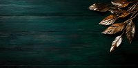 Golden metallic feathers against dark emerald green wooden background with dramatic lighting and copy space for luxury design projects and festive layouts.