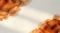 Abstract watercolor background with flowing orange and brown organic shapes creating artistic texture for creative projects and design elements.