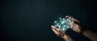 Hands holding glowing digital data cubes against dark background, representing technology, innovation, and digital transformation for business and corporate applications.