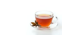 Glass cup of aromatic tea with star anise spice on white background. Hot beverage for relaxation and wellness. Isolated transparent mug for design projects.