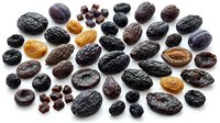 Assorted dried raisins, prunes, and currants in various sizes and shades arranged on white background for food, nutrition, and culinary design projects.