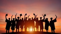 Silhouettes of graduates in caps and gowns celebrating success against a vibrant sunset sky, raising diplomas and hats in triumph.