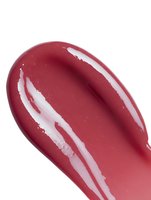 Glossy red lipstick swatch with smooth texture and subtle shimmer, isolated on white background for beauty product advertising.