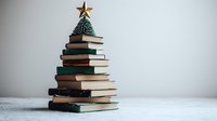 Creative Christmas tree made from stacked vintage books topped with golden star decoration against white background, minimal holiday concept for libraries and education.