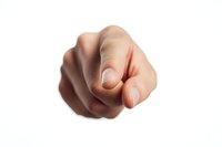 Pointing finger gesture of Caucasian male hand isolated on white background, showing direction or blame. Dramatic lighting emphasizes authority and accusation.
