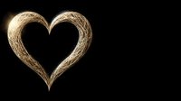 Golden heart shape created with light trails against black background for romantic designs and Valentine's Day projects.