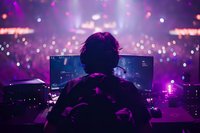 DJ performing at nightclub with purple lighting and bokeh effects, view from behind mixing console showing dual monitor setup and atmospheric club environment.