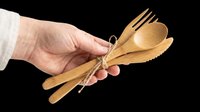 Wooden utensils set with fork, knife and spoon tied together, held in hand. Isolated on transparent background, ready for clipart, t-shirt design, print-on-demand and sublimation projects.