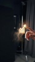Businessman finger touching glowing growth chart with upward arrow showing financial success and business development in modern office environment.