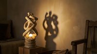 Wooden twisted sculpture with warm light casting dramatic shadow on wall, creating artistic interior decor and atmospheric ambiance for home design projects.