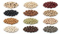 Assorted legumes and beans isolated on white background including cashews, chickpeas, black beans, pinto beans, lentils and peas for cooking and nutrition.