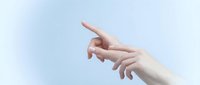 Two elegant female hands reaching toward each other against soft blue sky background, symbolizing connection, unity and human touch in minimalist style.