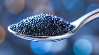 Black caviar on silver spoon with blue bokeh background, luxury gourmet food close up macro photography for restaurant menu and fine dining promotion.
