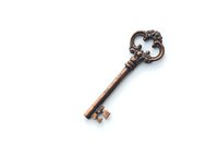 Vintage copper skeleton key with ornate baroque style bow and decorative pattern isolated on white background for design projects and creative layouts.
