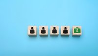 Wooden blocks showing business team transformation with dollar sign representing financial growth and success on blue background.