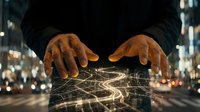 Male hands with medium skin tone positioned over glowing digital network lines and data streams on tablet, representing technology, connectivity, and business innovation in urban setting.