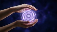 Hands holding a glowing purple energy orb with swirling light on a dark cosmic background, evoking magic, power, and spiritual energy.