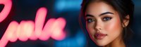 Young woman with South Asian ethnicity, dark hair, and bold makeup featuring pink eyeshadow, posed against neon pink and blue glowing lights. Suitable for modern beauty, cosmetics, nightlife, and contemporary lifestyle marketing campaigns.