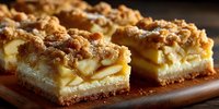 Layered apple crumb bars with golden crust and streusel topping on wooden board. Homemade dessert squares with fruit filling and crumbly texture for bakery menu.