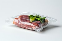 Fresh raw meat and broccoli sealed in transparent vacuum package on white background, food preservation and storage concept for cooking preparation.