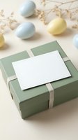 Easter gift box with blank card and pastel eggs on neutral background for spring holiday greeting design and seasonal marketing materials.