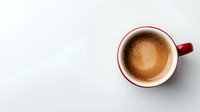 Fresh espresso with creamy foam in red and white ceramic cup on white background, top view composition with copy space for menu or cafe design.