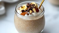 Healthy chia seed pudding with nuts, dried fruits and yogurt topping in glass jar. Nutritious breakfast or dessert for wellness lifestyle and clean eating.