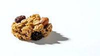 Homemade granola bar with oats, nuts and dried fruits on white background. Healthy snack food isolated for packaging design and nutrition concepts.