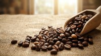 Roasted coffee beans spilling from wooden scoop onto burlap fabric with warm sunlight streaming through window, suitable for beverage packaging and café marketing materials.