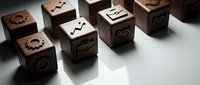 Wooden cubes with carved symbols and icons arranged on white surface for business concept design and educational materials.