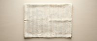 Natural beige linen kitchen towel with folded texture on neutral background for cooking and home decor applications.