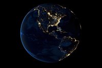 Earth at night showing city lights across North America and South America against dark space, representing global connectivity, urbanization, and planetary infrastructure for business and technology concepts.