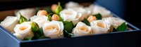 Elegant white roses arranged in luxury gift box with soft lighting creating romantic atmosphere for special occasions and celebrations.