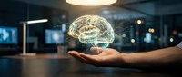 Glowing digital brain hologram floating above open palm in modern office environment representing artificial intelligence and neural networks.