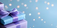 Purple and blue wrapped gift boxes with satin ribbon bows against dreamy bokeh background. Festive holiday celebration concept with soft glowing lights.