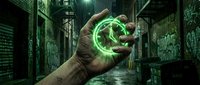 A hand holds a glowing green orb of energy in a dark urban alley surrounded by graffiti walls, representing magic, power, technology, and futuristic concepts for design projects.