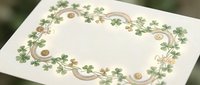 Elegant clover shamrock border frame with golden accents on textured paper background for St Patricks Day greeting cards and festive designs.