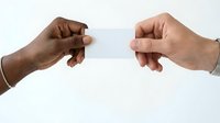 Two diverse hands exchanging blank white card on isolated background, suitable for business, networking, contact information, and corporate communication designs.