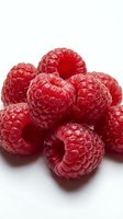 Fresh red raspberries isolated on white background with water droplets, suitable for food, nutrition, healthy eating, and culinary design projects.