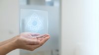 Hands presenting holographic digital interface with geometric pattern in modern office environment for technology and innovation concepts.