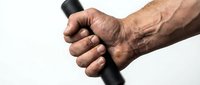 Senior man's weathered hands gripping black walking cane handle on white background, showcasing aging, mobility support, and independence in elderly care.