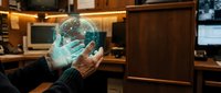 Hands holding glowing digital globe with network connections in modern office workspace, representing global business, technology innovation, and worldwide communication solutions.