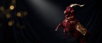 Demonic creature with horns and textured skin emerging from darkness with dramatic lighting and golden bokeh effects for horror and fantasy projects.