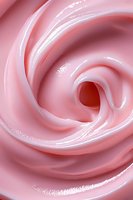Soft pink swirling cream texture in macro view showing smooth glossy surface with gentle curves and spiral pattern, suitable for cosmetic and beauty industry backgrounds.