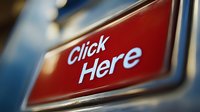 Red button with white text saying Click Here on blurred background. Close up view of interactive web element or digital interface button for online marketing and call to action designs.