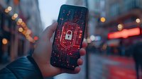 Smartphone displaying digital security lock icon on glowing red circuit pattern against blurred urban evening background with bokeh lights. Cybersecurity concept.